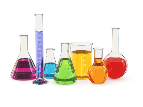 Laboratory glassware with a colorful liquid, isolated on white background.
