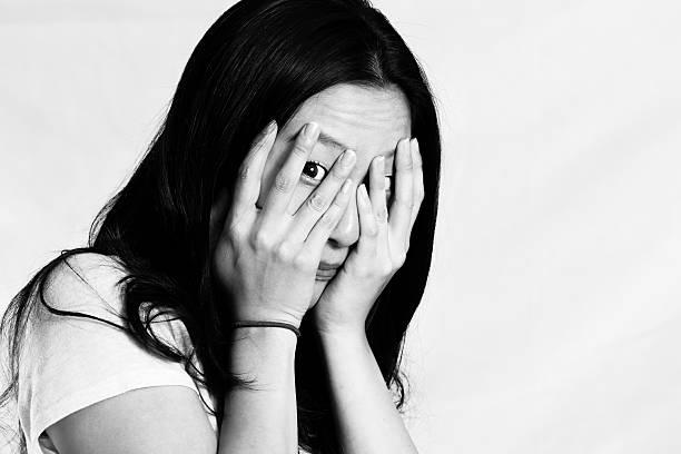 istock Young woman covering her face 453854769