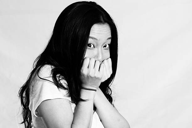 istock Young woman covering her face 453854785