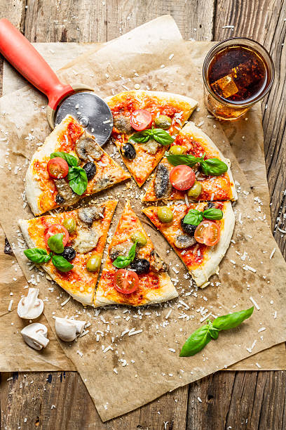 istock Cutting homemade pizza with basil 453857027