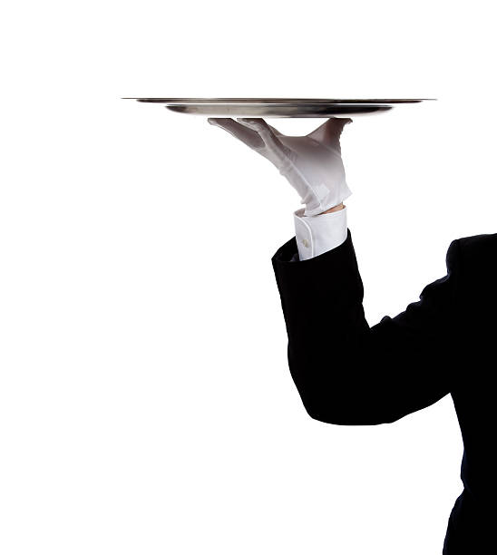 istock Butler's gloved hand holding a silver tray 453858255