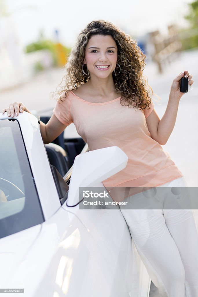 Woman holding keys of her car Happy woman holding keys of her new car Car Stock Photo