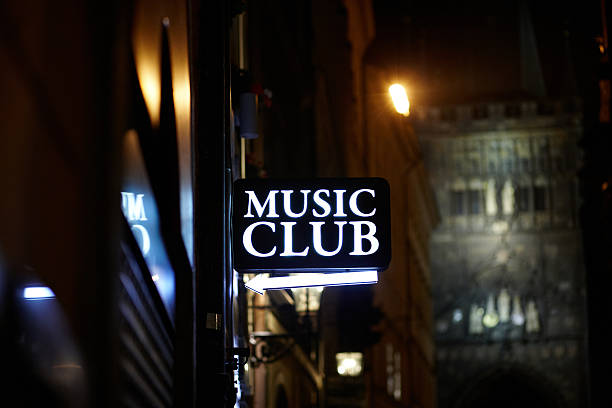 Illuminated music club sign at night