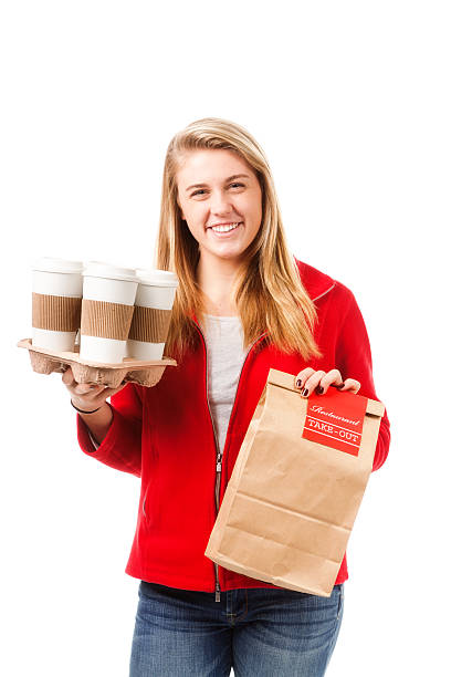 Teen with Take Out Food and Drinks on White Background Subject: Young woman with take-out hot drinks and food delivered. Isolated on white background. girls getting ready to go out stock pictures, royalty-free photos & images