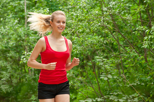 istock Young woman jogging outdoors 453892559