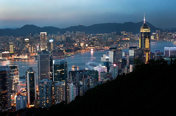 Hong Kong evening cityscape and Central Plaza HONG KONG - JUNE 2013 - Hong Kong cityscape and Central Plaza skyscraper at dusk. central plaza hong kong stock pictures, royalty-free photos & images