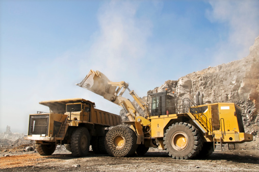 Loading heavy dump truck at the opencast mining