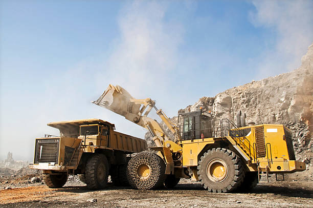 Super Tracks Loading heavy dump truck at the opencast mining construction truck bulldozer wheel stock pictures, royalty-free photos & images