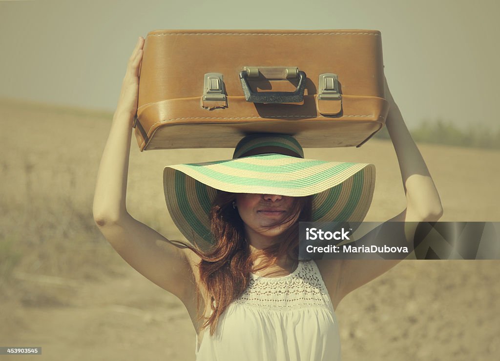 Young woman in a sun hat holding luggage on her head Young woman enjoying her pregnancy in the countryside Women Stock Photo