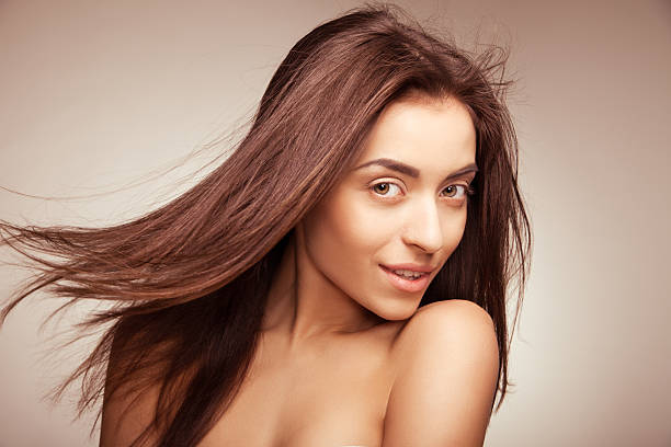istock Attractive smiling woman with long hair on grey 453903929