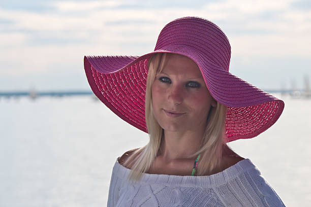 istock Young woman with a pink sun hat 453909613