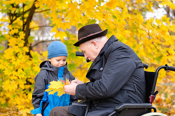 istock Elderly disabled man playing with his grandson outdoors 453910579