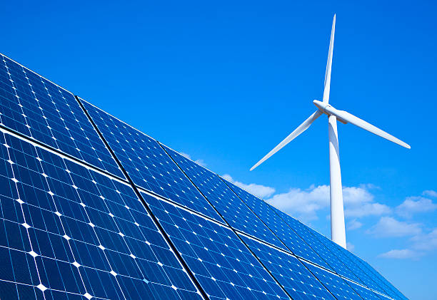 Renewable Energy Solar panels and wind turbine against blue sky wind power stock pictures, royalty-free photos & images