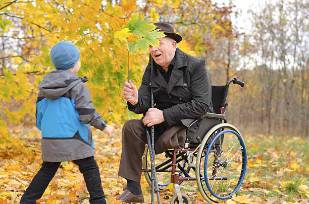istock Young boy playing with his disabled grandfather 453911431