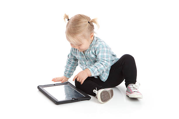 istock Toddler Girl Playing with Touch Screen Digital Tablet 453911805