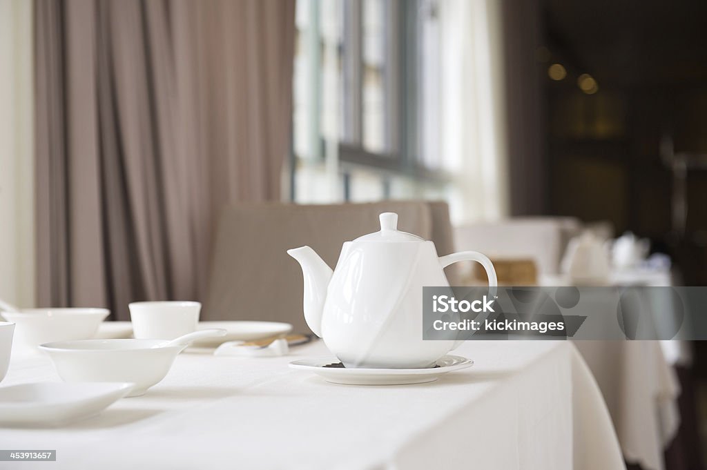 Chinese Yum Cha Close-up of Chinese teapot, bowls and tea cups on dining table, in a restaurant. Asia Stock Photo