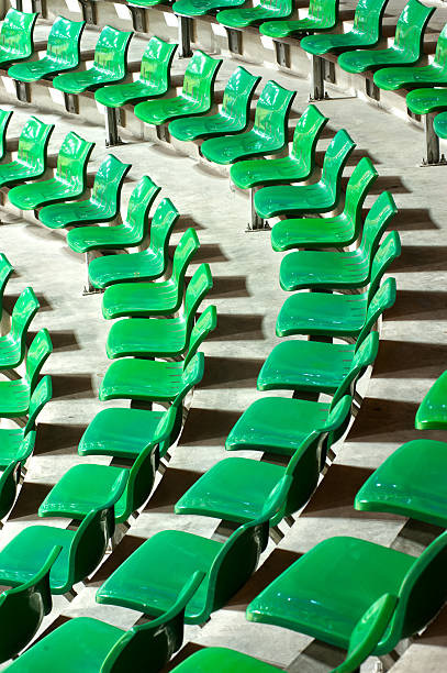 istock Plenty of green plastic seats at stadium . 453913767