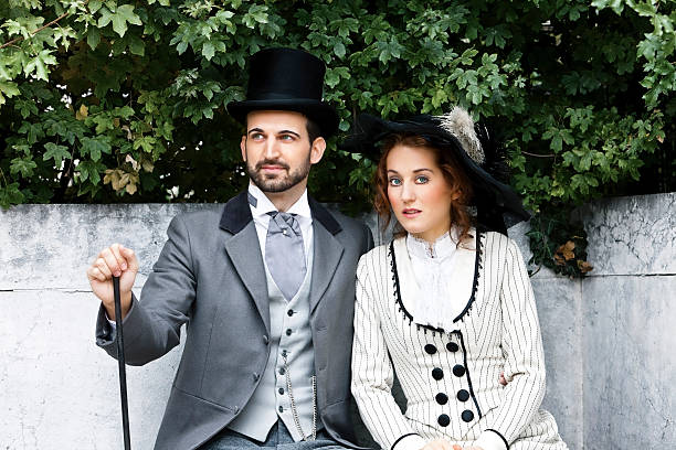 istock Old-fashioned dressed couple in the park 453918411