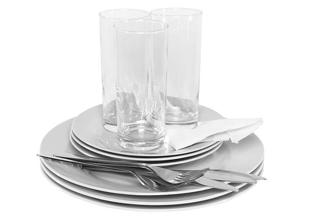 istock Pile of white plates, glasses, forks, spoons. 453919701