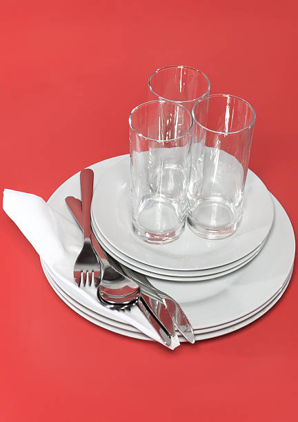 istock Pile of white plates, glasses, forks, spoons. 453919705