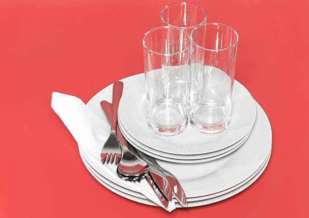 istock Pile of white plates, glasses, forks, spoons. 453919707