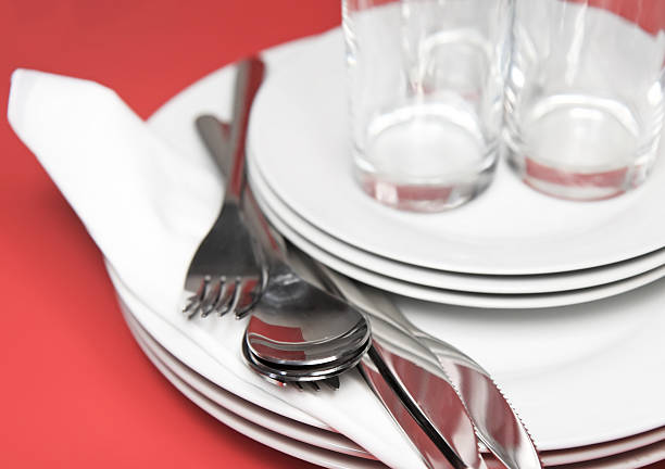 istock Pile of white plates, glasses, forks, spoons. 453919709