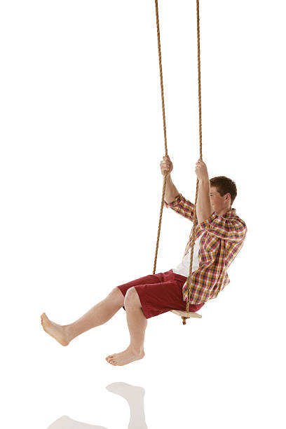 istock Happy young man on a rope swing 453920775