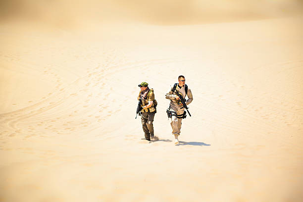 istock Special Ops Officers With Rifle On Sand Dunes 453921305