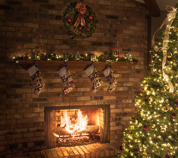 istock Christmas fireplace, quilted stockings, roaring fire, tree, lights, ornaments 453921887