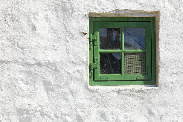 istock green old window on white wall architecture detail 453926395