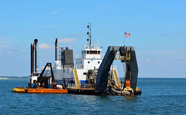 Dredger at ocean inlet Dredging on the ocean inlet at St. Augustine, Florida crane machinery photos stock pictures, royalty-free photos & images