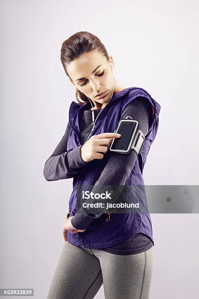 Woman Athlete Preparing For A Run Stock Photo - Download Image Now - Arm Band, Running, 20-24 Years