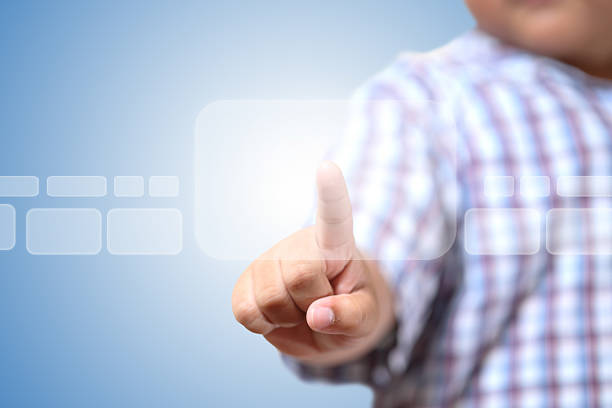 istock Hand of little Boys pushing on touch screen interface 453934743