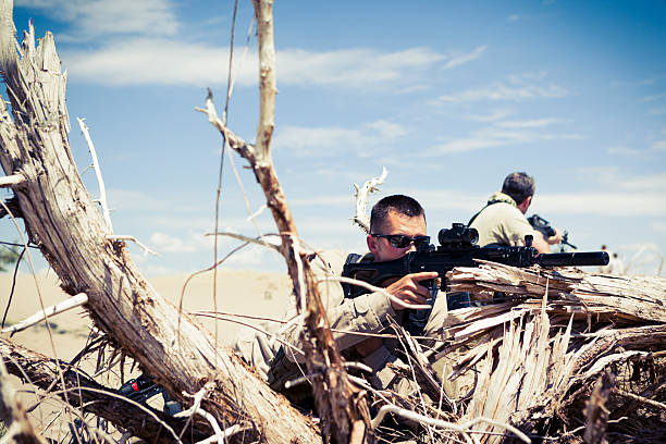 istock Special Ops Officers With Rifle On Sand Dunes 453938811