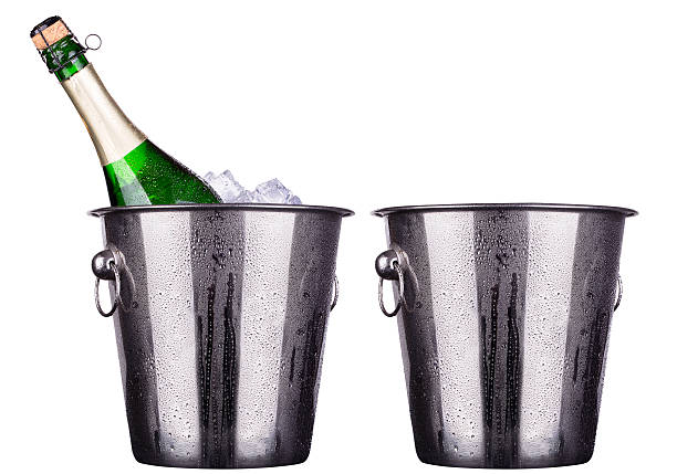 istock bottle of champagne in ice bucket and empty 453944219