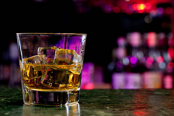 istock Cup with whiskey and ice cubs on a bar balcony 453952343