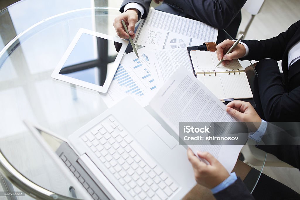 Discussion of papers Image of human hands during paperwork at meeting Arranging Stock Photo