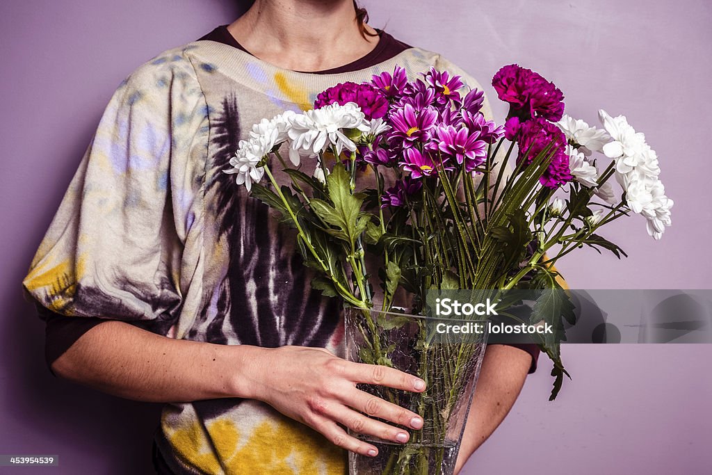 Young woman with bouquet of fresh flowers Young woman with a bouquet of fresh colorful flowers Adult Stock Photo