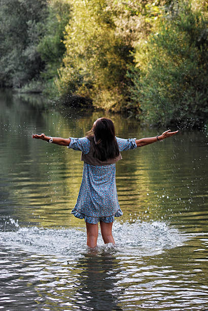 istock Young woman praying in lake 453955851