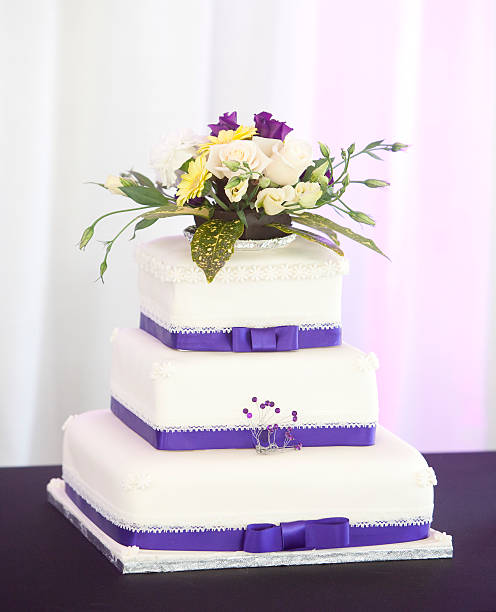 istock Wedding cake at a reception decortaed with flowers 453958163