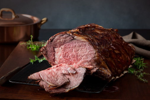 A prime rib roast beef, sliced open to show medium rare meat.  Very shallow DOF.