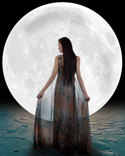 backside view of an ice princess in front of a full moon - godin stockfoto's en -beelden