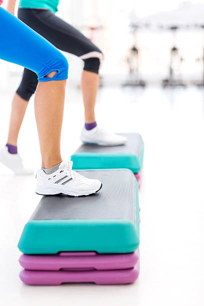istock Women's Leg Doing Step Aerobics In Gym 453969355