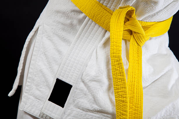 Judo yellow belt Judo yellow belt yellow belt stock pictures, royalty-free photos & images