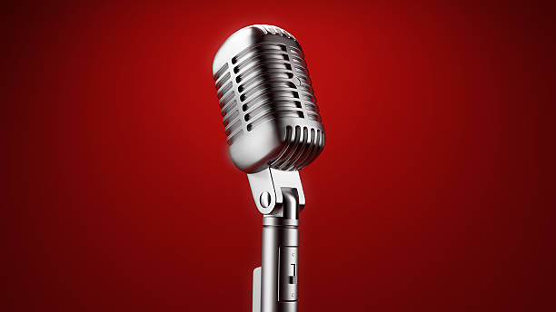 A vintage microphone in front of a red background