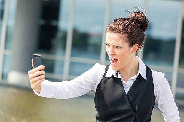 istock Young Businesswoman Shouting on Mobile Phone 453977897