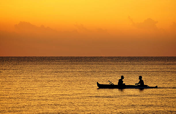 istock Fishermen Paddling a boat at sunset 453992695