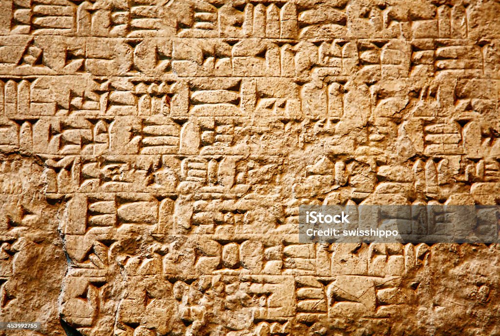 Cuneiform writing on ancient clay wall Cuneiform writing of the ancient Sumerian or Assyrian civilization in Iraq Cuneiform Stock Photo
