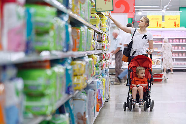 Mother with her boy in the supermarket Mother with her boy in baby carriage in the supermarket supermarket family retail cable car stock pictures, royalty-free photos & images