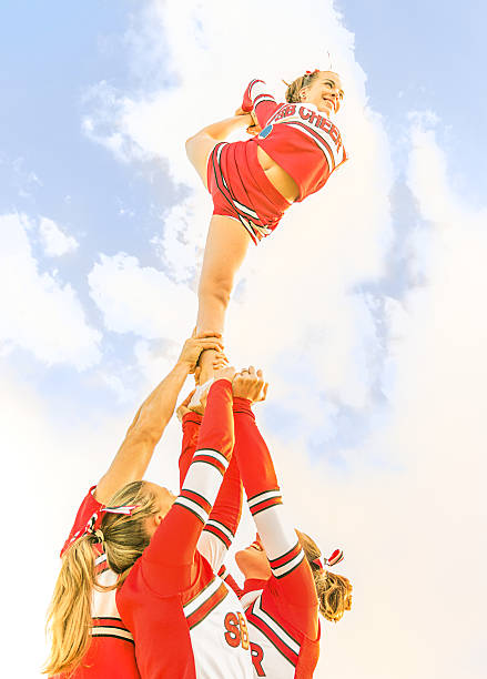 istock Young cheerleader balancing toward the sky - Cheerleaders Team 453996695
